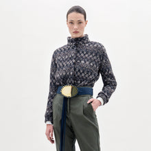 Load image into Gallery viewer, A person stands against a plain background wearing the Zalta Jacket, olive green pants, and a wide blue belt with a large gold buckle.