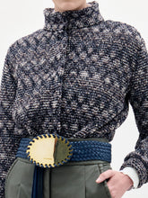 Load image into Gallery viewer, A person stands against a plain background wearing the Zalta Jacket, olive green pants, and a wide blue belt with a large gold buckle.