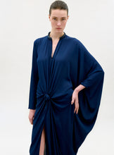 Load image into Gallery viewer, Woman wearing a navy blue dress with a knot detail on a white background