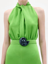 Load image into Gallery viewer, A woman stands facing forward in the Siv Jumpsuit, a bright green halter-neck style with wide-leg pants and a matching belt, paired with black sandals, against a plain white background.
