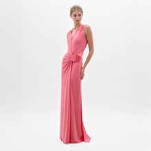 Load image into Gallery viewer, A woman stands against a white background wearing the Fadila Dress, a sleeveless, floor-length pink dress featuring gathered detailing at the waist.