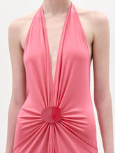 Load image into Gallery viewer, A woman stands against a plain background wearing the sleeveless pink Veracruz Dress with a gathered waist, holding a large beige fringed bag and wearing brown sandals.