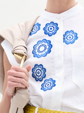 Load image into Gallery viewer, A person wearing the Adele Blouse in color White Navy Embroidery with a Sofia Bag Maxi in color Beige on a white background.