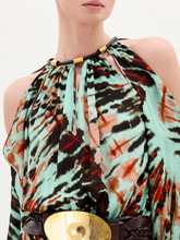 Load image into Gallery viewer, A woman wears the Carla Dress, a long patterned maxi with cut-out shoulders, a gathered neckline, long sleeves, a wide belt, and crafted from luxurious Italian fabric, standing against a plain white background.