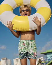 Load image into Gallery viewer, Boy holding a yellow and white inflatable ring with a clear blue sky in the background.
