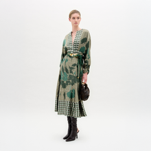 Load image into Gallery viewer, Woman wearing a green and beige patterned dress with black boots on a white background