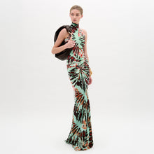 Load image into Gallery viewer, A woman wears the Frances Dress, a sleeveless, slim-fit maxi with a high neckline, holding a dark jacket over her shoulder against a plain white background.