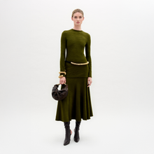 Load image into Gallery viewer, Woman wearing a green outfit with a skirt and sweater on a white background
