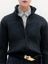 Load image into Gallery viewer, A person wearing the Zalta Jacket in color Black with a golden belt on a white background.