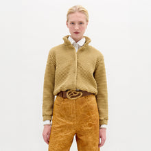 Load image into Gallery viewer, A blonde woman stands against a plain background wearing the Zalta jakcet in color Gold