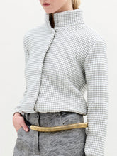Load image into Gallery viewer, A person wearing the Zalta Jacket in color Silver with a golden belt on a white background.