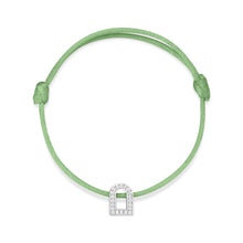 Load image into Gallery viewer, Introducing the L'Arc Voyage Charm PM, a refined bracelet featuring a silk green cord and an 18k white gold pendant adorned with Galerie diamonds in a distinctive horseshoe shape from Paris Atelier. The bracelet includes adjustable knots on either side to ensure a perfect fit.