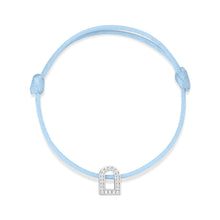Load image into Gallery viewer, The L'Arc Voyage Charm PM bracelet, crafted by Paris Atelier, features an elegant arch-shaped charm in 18k white gold embellished with Galerie diamonds. This light blue silk cord piece is adjustable and finished with simple knots on each end.