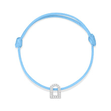 Load image into Gallery viewer, Introducing the L'Arc Voyage Charm PM, an exquisite bracelet crafted by Paris Atelier. This piece features a silk cord in a vibrant blue hue, complemented by an 18k white gold charm adorned with Galerie Diamonds and crystal-embellished arch details. The design includes adjustable sliding knots for a perfect fit, while the charm adds an elegant touch to the colorful bracelet.