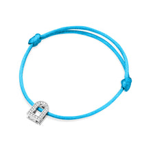 Load image into Gallery viewer, The L'Arc Voyage Charm PM is a turquoise silk cord bracelet adorned with an 18k white gold padlock charm encrusted with Galerie Diamonds, designed by Paris Atelier. It features secure knots that contribute to its elegant yet minimalist appeal.