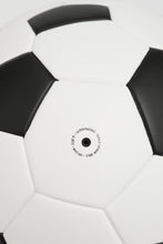 Load image into Gallery viewer, Close-up of a black and white soccer ball with visible branding on a light gray background
