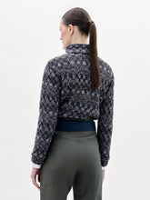 Load image into Gallery viewer, A person stands against a plain background wearing the Zalta Jacket, olive green pants, and a wide blue belt with a large gold buckle.
