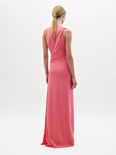 Load image into Gallery viewer, A woman stands against a white background wearing the Fadila Dress, a sleeveless, floor-length pink dress featuring gathered detailing at the waist.
