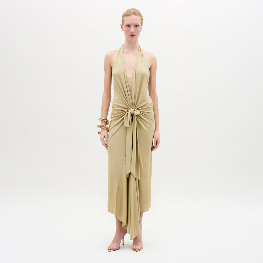 A woman wearing the Adara Dress on a white background