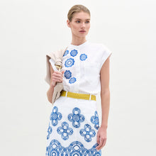 Load image into Gallery viewer, A woman wearing the Adele Blouse in color White Navy Embroidery with the Sofia Bag Maxi in color Beige on a white background.
