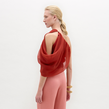 Load image into Gallery viewer, A person stands against a plain background wearing the Adil blouse 
