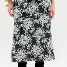 Load image into Gallery viewer, A person stands against a plain background wearing the Blair Skirt
