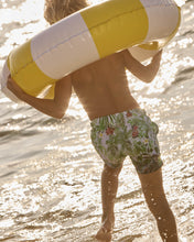 Load image into Gallery viewer, Boy holding a yellow and white life buoy on a beach.
