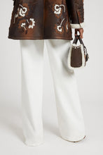 Load image into Gallery viewer, Palazzo trousers in white denim with floral cut-out
