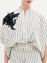 Load image into Gallery viewer, A person wearing the Daia Blouse in color Black White Stripes  on a white background.
