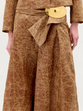 Load image into Gallery viewer, A person stands against a plain background wearing the Olga Skirt in color Caramel.
