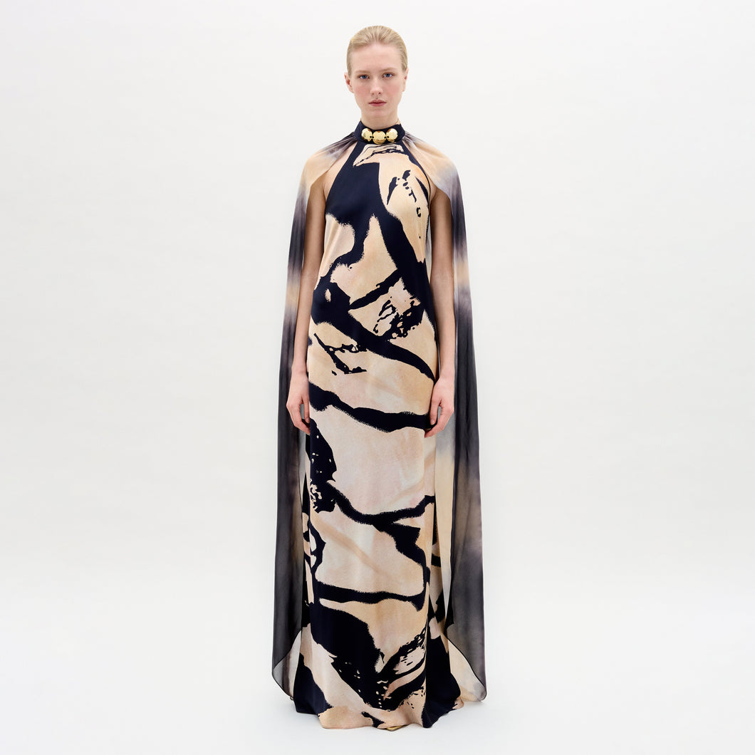 A woman wearing the Sabina Dress in color Black Beige Abstract on a white background.