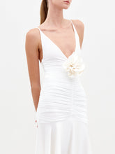 Load image into Gallery viewer, A person stands against a plain background wearing the Sana dress in color White
