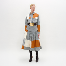 Load image into Gallery viewer, Woman wearing a patchwork dress with orange, gray, and white colors on a white background
