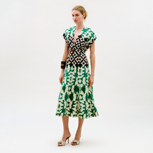 Load image into Gallery viewer, Woman wearing a green and white patterned dress on a white background

