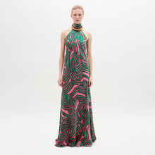 Load image into Gallery viewer, A woman wearing the Tila Dress in color Pink Green Abstract with a golden necklace on a white background.
