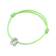 Load image into Gallery viewer, The L'Arc Voyage Charm PM bracelet from Paris Atelier is a stunning piece, featuring an 18k white gold charm adorned with Galerie diamonds, reminiscent of a padlock. This elegant design offers seamless size adjustment with knots on each side of the charm, while its vivid silk cord adds a touch of classic sophistication.
