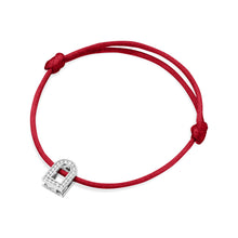 Load image into Gallery viewer, The L'Arc Voyage Charm PM bracelet, crafted from 18k white gold and adorned with Galerie diamonds, features a red silk cord that loops elegantly with a simple knot on each side. This minimalist design effortlessly captures the timeless sophistication of a Paris atelier.
