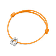 Load image into Gallery viewer, The L'Arc Voyage Charm PM bracelet features an 18k white gold charm shaped like a lock, adorned with Galerie diamonds, and is elegantly tied on a silk cord using simple knots. Crafted with the refined artistry of a Paris Atelier.
