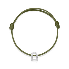 Load image into Gallery viewer, The L'Arc Voyage Charm PM bracelet from Paris Atelier showcases a silk cord in a gentle green hue, adorned with an intricate 18k white gold charm sprinkled with Galerie diamonds, elegantly shaped like an arch or door. It features adjustable knots on each side for a personalized fit.
