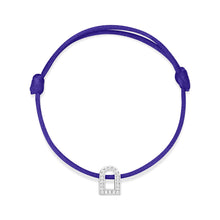 Load image into Gallery viewer, The L'Arc Voyage Charm PM from the Paris Atelier collection features a royal blue silk cord and a small, white gold charm embellished with Galerie diamonds. This bracelet includes adjustable knots for customized sizing.
