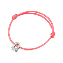 Load image into Gallery viewer, The L'Arc Voyage Charm PM is a pink silk cord bracelet by Paris Atelier, showcasing an 18k white gold padlock charm adorned with Galerie diamonds. It includes adjustable knots for easy resizing.
