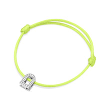 Load image into Gallery viewer, A bracelet with a silk cord in neon green tied in two adjustable knots, featuring the L'Arc Voyage Charm PM crafted from 18k white gold with Galerie diamonds.
